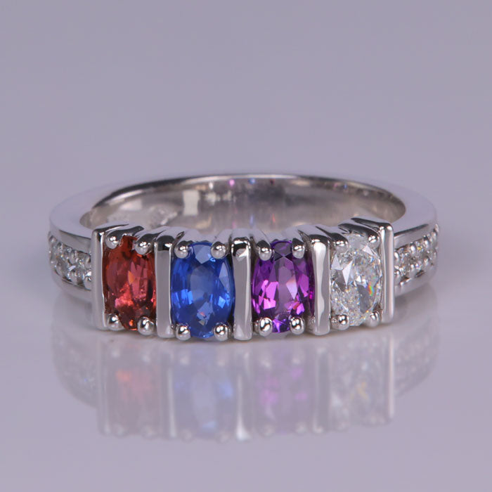 oval gemstone mother's ring with diamonds set in white gold