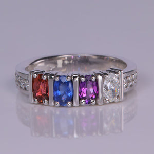 oval gemstone mother's ring with diamonds set in white gold