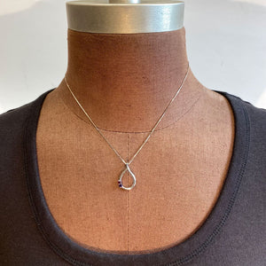 white gold teardrop pendant with gemstones