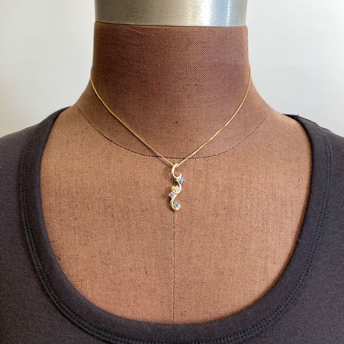 mothers four stone flowing pendant