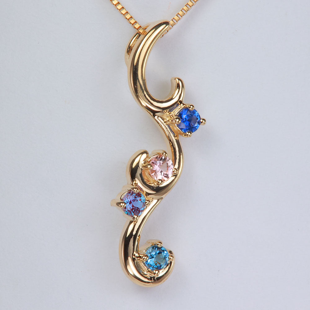 yellow gold mothers flowing pendant with four gemstones