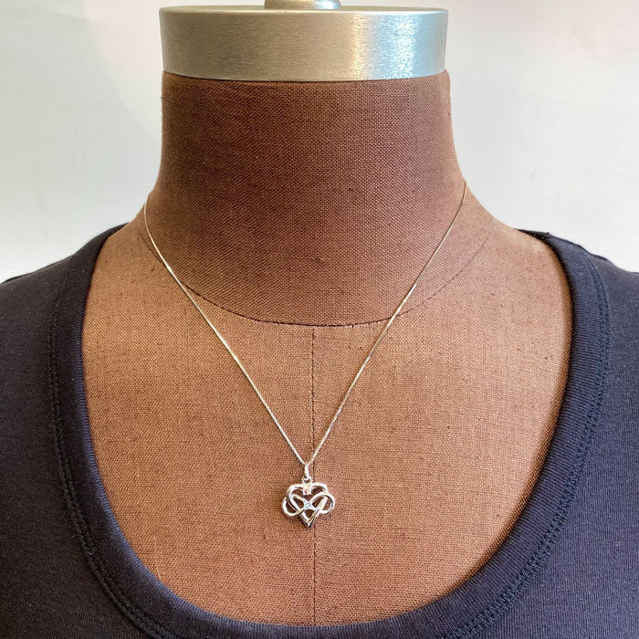 white gold infinity pendant with two gemstones