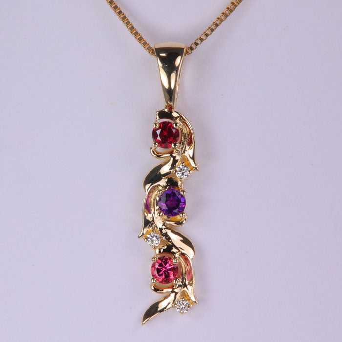 yellow gold mother pendant with three stones and diamonds