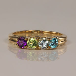 mother's ring in yellow gold with four gemstones and diamond accent